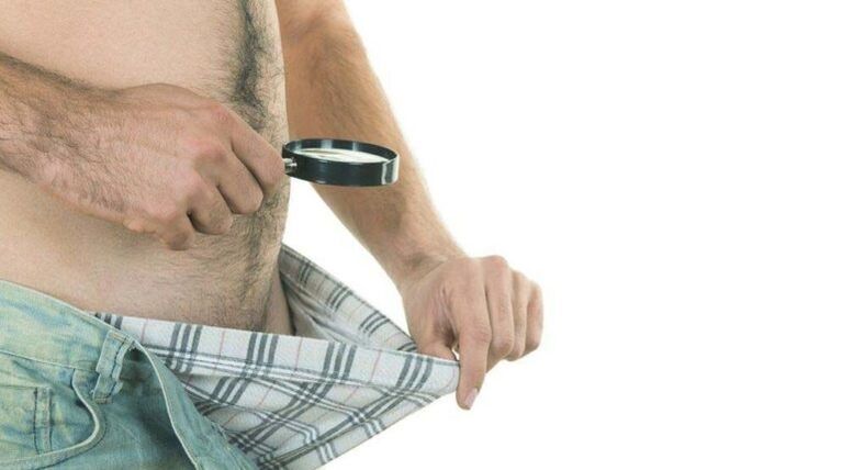 a man looks into his underwear and thinks about penis enlargement with soda